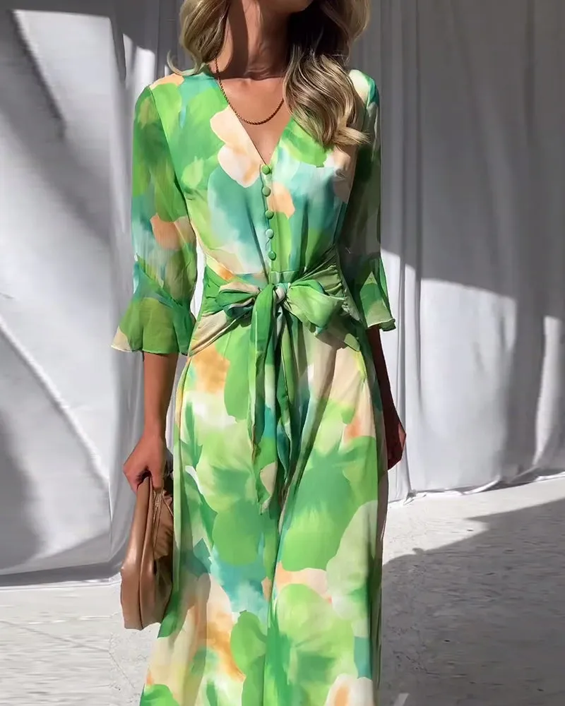 Elegant printed dress with bell sleeves and button slit