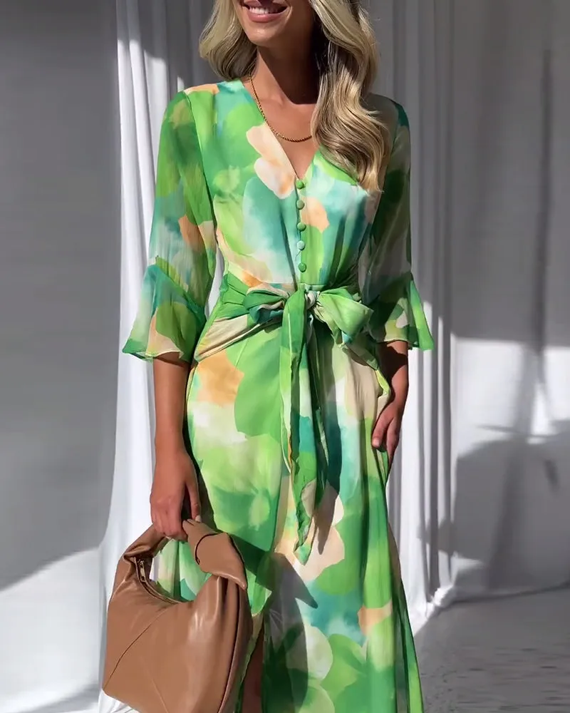 Elegant printed dress with bell sleeves and button slit